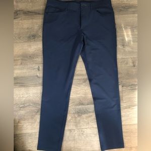 Men’s Public Rec slim tapered pants. 4 way stretch. Color is a dark navy blue.